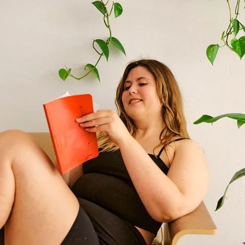 Young woman sitting on chair reading